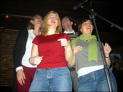 Kristin, Kris, Rachelle, Jess singing karaoke.